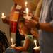 Sarah Osterholzer, 5, holds a candle as she looks on during a prayer vigil in support of Camp Take Notice at St. Mary Student Parish on Thursday night.  Melanie Maxwell I AnnArbor.com
